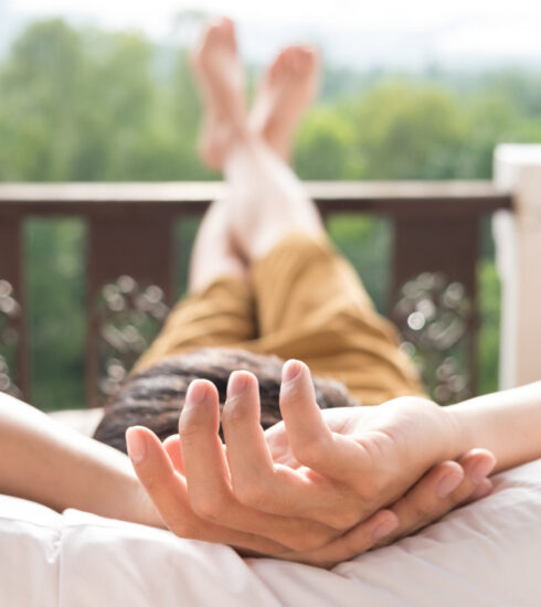 man relaxing on balcony